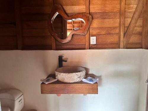 a mirror sitting on a shelf in a bathroom at bacalar My Love Front Laguna in Bacalar
