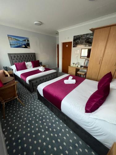 Ένα ή περισσότερα κρεβάτια σε δωμάτιο στο Berry Hotel