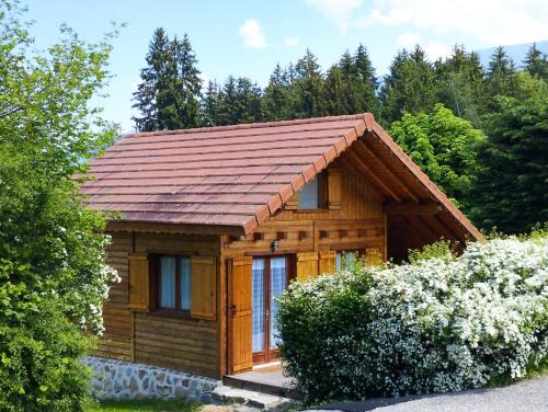 a small log cabin with a copper roof at Chalet individuel à proximité de la station Les 7 Laux in Les Adrets