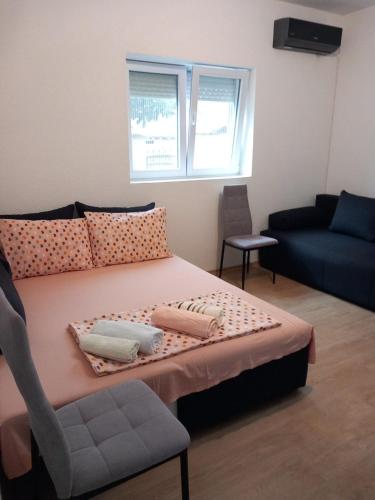 a bedroom with a bed with a chair and a couch at Villa 17 in Gevgelija