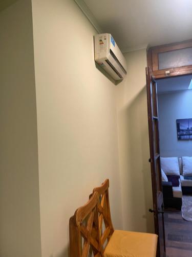 a room with a chair and a air conditioner on the wall at Manolo in Santa Rosa