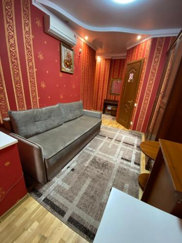 a couch in a room with red walls at Near the Lake in Lviv