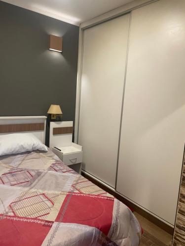 a bedroom with a bed and a white wall at Manolo in Santa Rosa