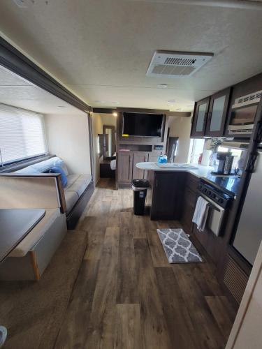 an interior view of an rv kitchen and living room at Beach and Bay Glamping in Bolivar Peninsula