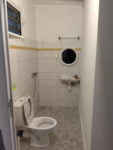 a bathroom with a toilet and a sink at Weston in Deshaies