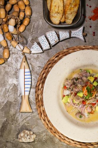 a table with a bowl of soup and a plate of food at Pousada Movimento in Prea