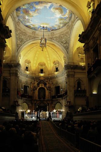 a large room with people sitting at tables in a church at Ibis Elche in Elche