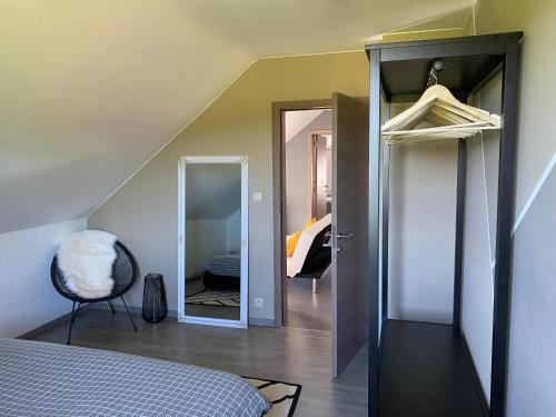 a bedroom with a door leading into a room at B&Bagatelle in Malmedy