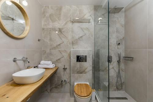 a bathroom with a sink and a glass shower at Pel Mar in Pefkohori