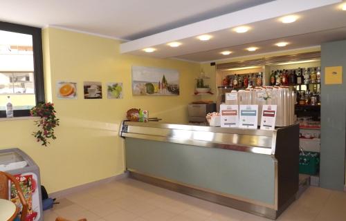 a restaurant with a counter with refrigerators at Hotel Villa Claudia in Bellaria-Igea Marina