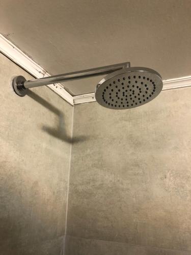 a shower with a shower head in a bathroom at Dormy Houses Payen in Las Lenas