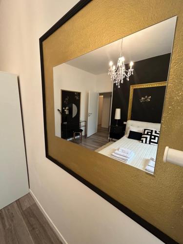 a mirror on the wall of a bedroom at Aurora Flowers - Two rooms and free parking near center and train station in Modena