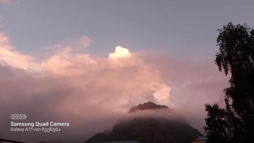 a view of a mountain with clouds in the sky at M7 House in Gorists'ikhe
