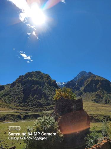 an image of a mountain with the sun in the sky at M7 House in Gorists'ikhe