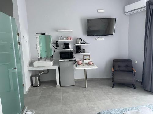 a room with a desk and a tv on a wall at Kavala Central Square View in Kavala