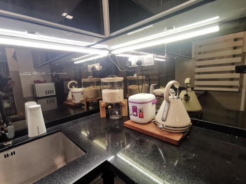 a kitchen counter with several appliances on a counter top at Enarahomes Shah Alam in Shah Alam