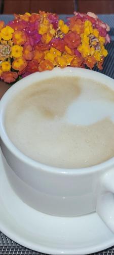 a bowl of milk sitting on a table with flowers at A ESTRENAR PRECIOSOS APARTAMENTOS APARTHOTEL INTER2, NEW APARTMENTS lN APARTHOTEL 12 months open! self check in! RESERVA Garaje! in Salou