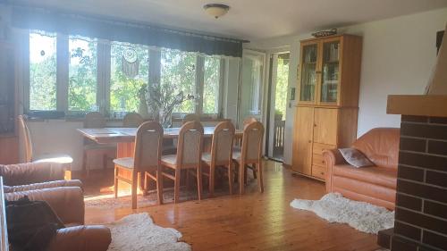 a kitchen and dining room with a table and chairs at Całoroczny duży dom na Mazurach n.Jeziorem Omulew. in Jabłonka