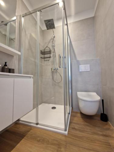 a shower stall in a bathroom with a toilet at Apartmani Maritimo in Seline