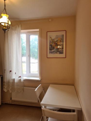 a dining room with a table and a window at Sea Apartment in Liepāja