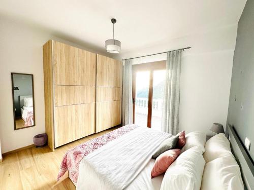 a bedroom with a bed and a large window at SWEET HOME in Himare