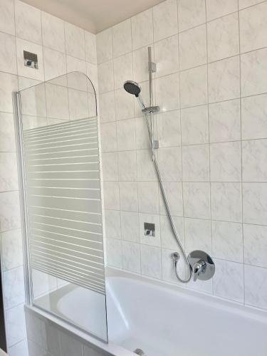 a shower with a glass door in a bathroom at Homely Stay Apartment 2 in Sankt Pölten