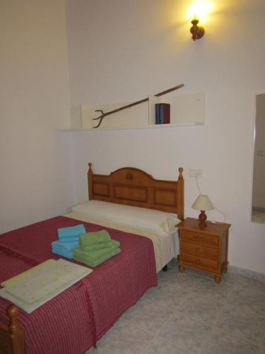 a bedroom with two beds and a table with a lamp at Casa Antonia ET- 6805 in Sant Francesc Xavier
