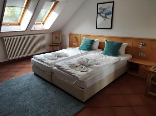 a bedroom with a large white bed with blue pillows at Ferienwohnung Wasserblick in Dewichow