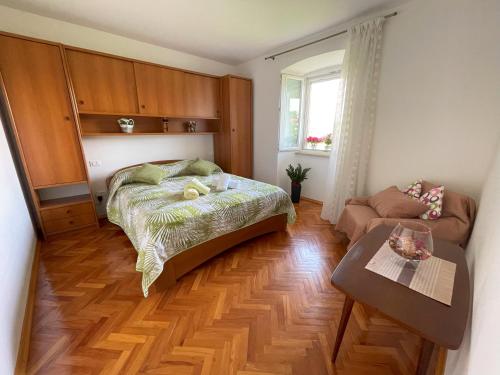 a bedroom with a bed and a couch and a table at Apartment Kaštel in Pazin