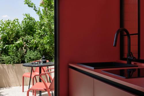 a kitchen with a sink and a table at DWELL - Elegant City Stay in Athens