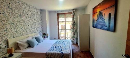 a small bedroom with a bed and a window at Aparhotel Mediterráneo by NeoHotels-Centro 8 min by Metro in Valencia