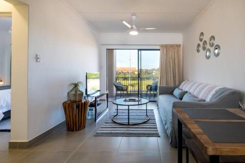 a living room with a couch and a table at Gorgeous Ballito One Bedroom apartment in Ballito