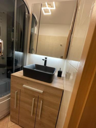 a bathroom with a black sink and a mirror at Apartments Salvore in Crveni Vrh