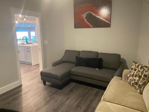 a living room with a couch and a chair at Clear Lake Retreat: Private pool, lakefront in Orlando