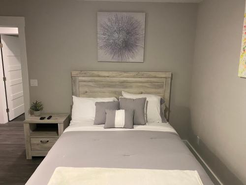 a bedroom with a large bed with white sheets and pillows at Clear Lake Retreat: Private pool, lakefront in Orlando