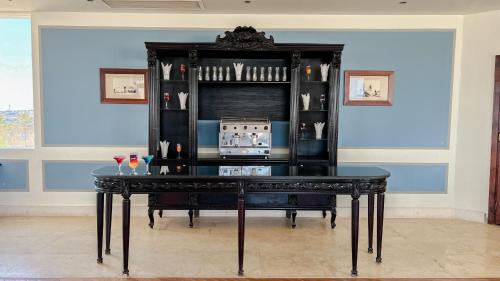 a black table with drinks on it in a room at Sharm Club Beach Resort in Sharm El Sheikh