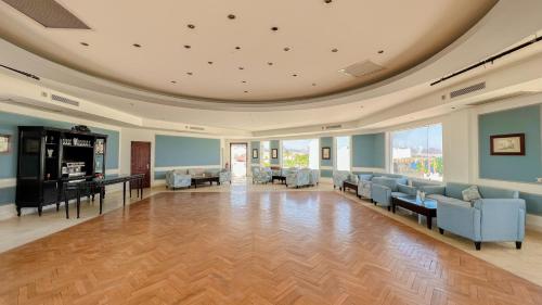 a large lobby with couches and chairs in a building at Sharm Club Beach Resort in Sharm El Sheikh