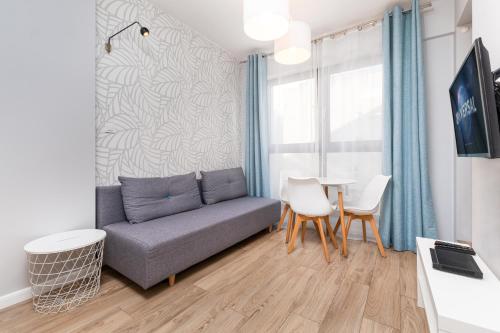 a living room with a couch and a table at Chłodna Apartment by Your Freedom in Warsaw