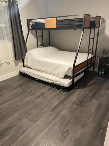 a bedroom with a bunk bed and a wooden floor at Clear Lake Retreat: Private pool, lakefront in Orlando