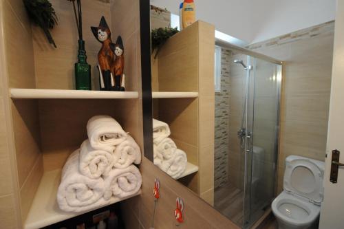 a bathroom with towels and a shower and a toilet at My Home in Naxos in Naxos Chora