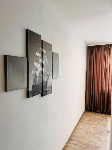 a room with three pictures on a wall at Sparrow apartmens 3 in Košice