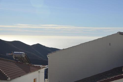 a view of the ocean from the roofs of buildings at Casa Eckhoff 3A Polopos- Underbar utsikt in Polopos