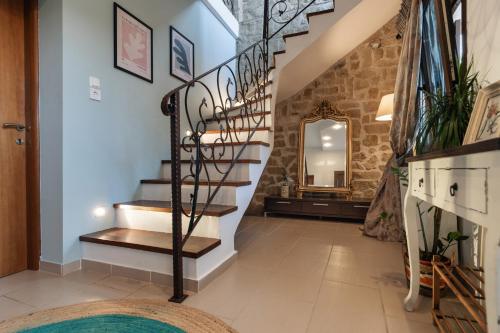 a staircase in a house with a mirror at The Serenity Stone Lodge in Kavala