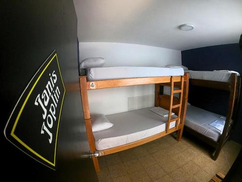 two bunk beds in a room with a chalkboard at Rock Hostel Medellin in Medellín