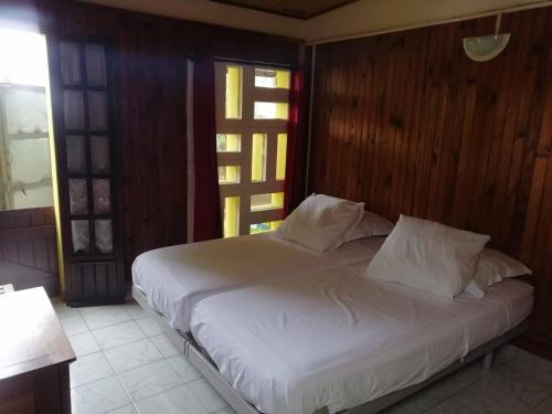 a bed with white sheets and pillows in a bedroom at maison de ville in Saint-Denis