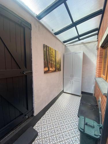 an empty room with a door and a room with a window at Baker House (Ormeau Road) 4Bed in Belfast