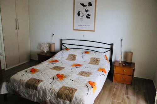 a bedroom with a bed with orange flowers on it at Corali luxury apartments in Malaki