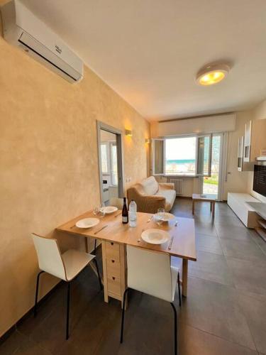 a room with a table and chairs and a living room at Suite Riminese with Beach Service in Rimini