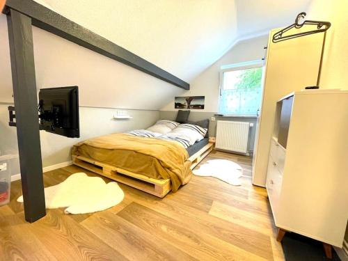 a bedroom with a bed and a flat screen tv at RobinsHomes-Industrial in Braunschweig