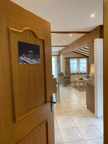 a door leading into a living room with a kitchen at Apartments Arcadia in Saas-Grund
